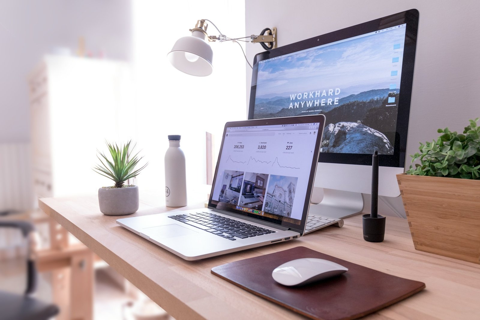 Professional web development workspace with laptop and desktop display for ZADX agency